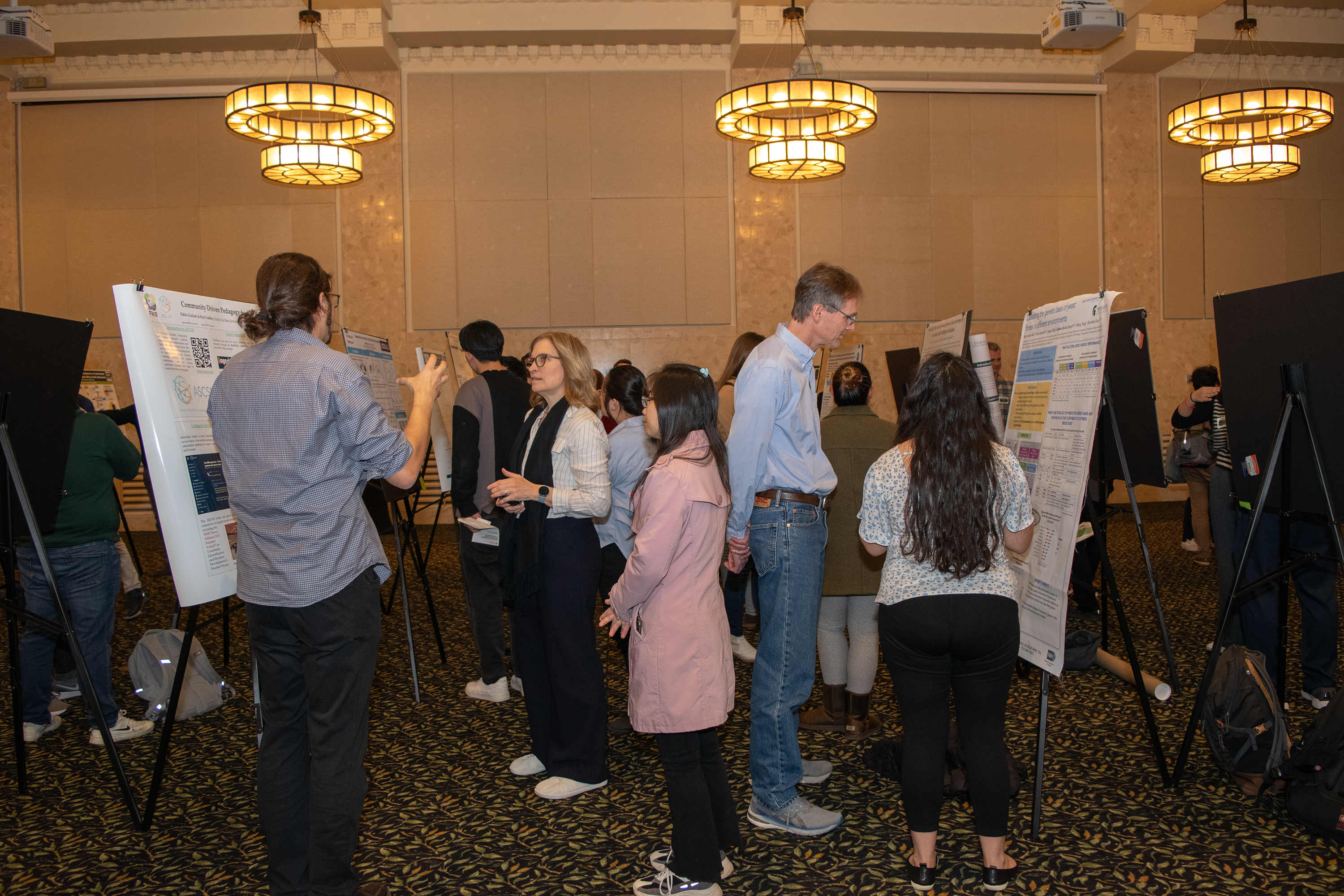 A group of people having discussions in front of research posters